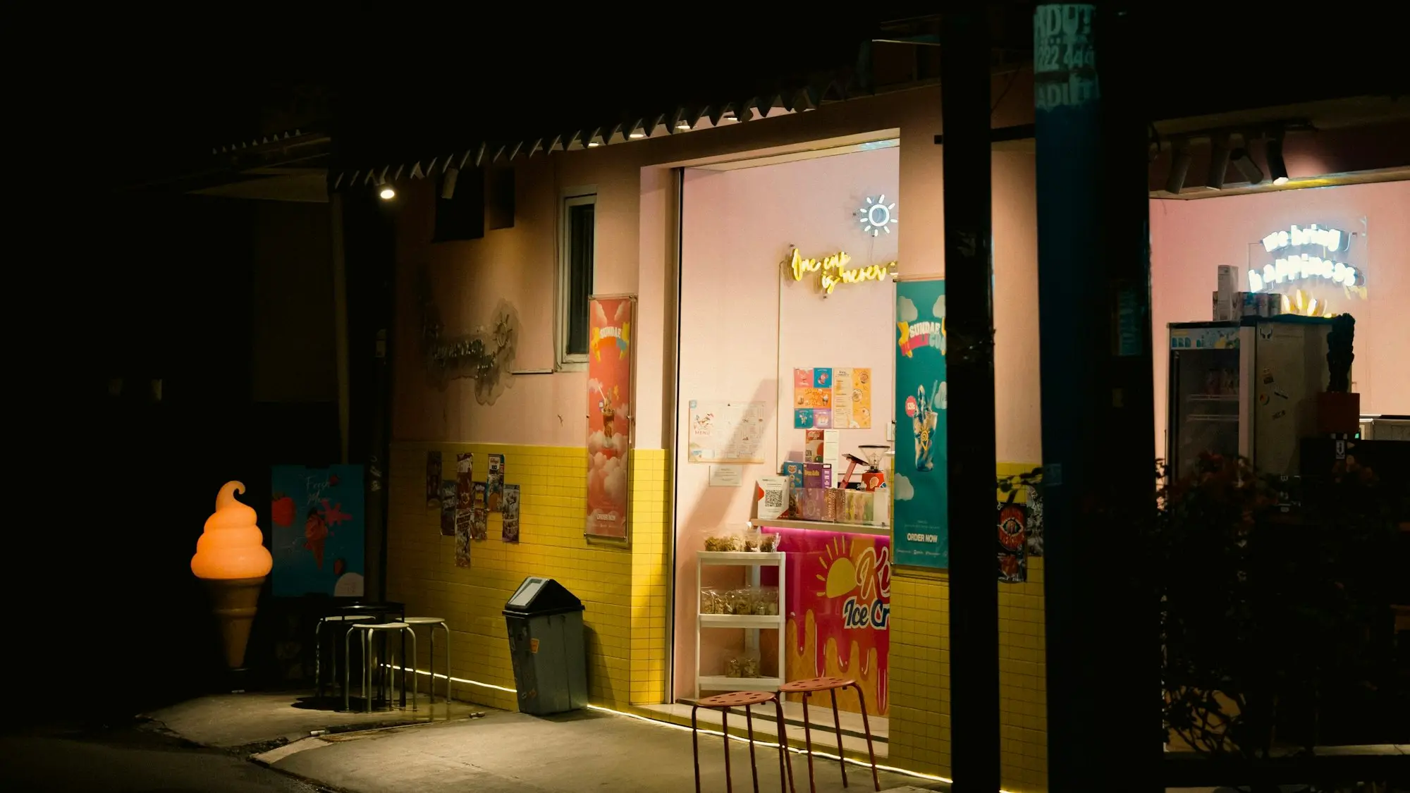 Brightly lit shop window at night on a quiet street